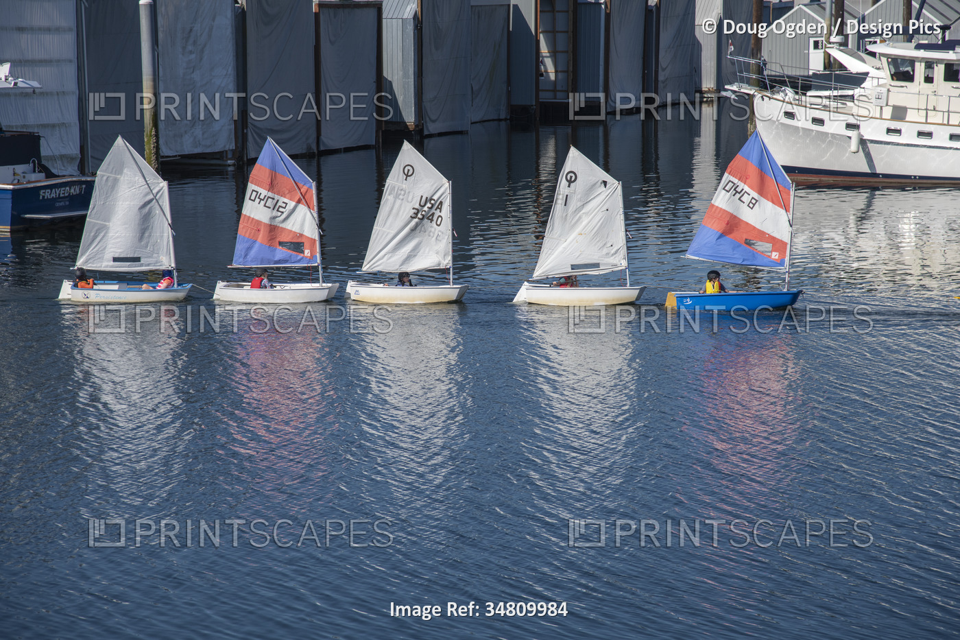 Young sailers being taken out into open water to get some sailing training at a ...